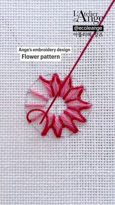 an embroidery pattern with red flowers on it