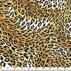 an animal print fabric with black and brown spots on it's fur, as well as a ruler