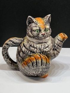 a ceramic cat figurine sitting on top of a table