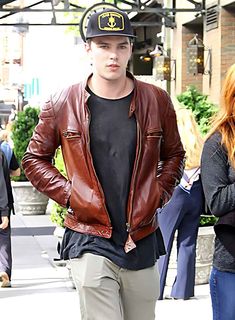 Enhance your style with exclusive Nicholas Hoult leather jacket, inspired by his iconic character Nux from the thrilling film Mad Max: Fury Road. Crafted with precision, this replica jacket captures the essence of Nux's stunning attitude and rugged charm. Made from high-quality leather, it exudes durability and timeless appeal.

Step into the post-apocalyptic world of Mad Max with our Mad Max Fury Road jacket. This jacket is a perfect blend of fashion and functionality, designed to make you stand out from the crowd. With its sleek leather exterior and attention to detail, it is a must-have for any fan of the film or fashion enthusiast.

Unleash your inner star and make a bold statement with Mad Max Fury Road jacket. Whether you're attending a special event or simply strolling down the stre Celebrities Leather Jacket, Casual Leather Jacket, Nicholas Hoult, Mad Max Fury, Collar Leather Jacket, Mad Max Fury Road, Leather Jacket With Hood, Fury Road, Fashion Enthusiast