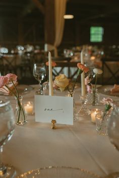 the table is set with flowers and candles for an elegant dinner or reception at this venue