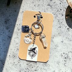 a keychain with several different items on it sitting on top of a table