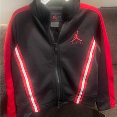 Brand New Toddler Jordan Jacket. Black, Red, & White. See Photos. Jordan Clothes, Kids Quilted Jacket, Air Jordan Jacket, Air Jordan Red, Boys Puffer Jacket, Jordan Jackets, Gym Jacket, Red Jordans, Track Suit