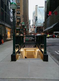 an entrance to a subway station on a city street