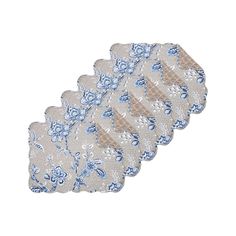 four blue and white placemats with flowers on them, one has a lace edge