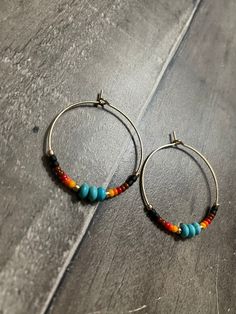 Aztec sunset seed bead and turquoise stone beaded gold hoops Bohemian Heishi Beads Small Hoop Earrings, Bohemian Small Hoop Heishi Bead Earrings, Bohemian Heishi Beaded Hoop Earrings, Bohemian Hoop Beaded Earrings With Heishi Beads, Bohemian Hoop Earrings With Heishi Beads, Bohemian Heishi Beads Hoop Earrings, Bohemian Hoop Earrings With Tiny Beads, Bohemian Turquoise Hoop Earrings With Colorful Beads, Adjustable Turquoise Hoop Earrings For Festival