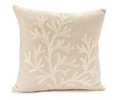 a white pillow with an embroidered design on it