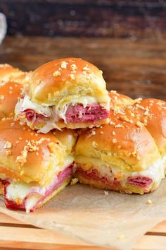 ham and cheese sliders stacked on top of each other with sesame seed sprinkles