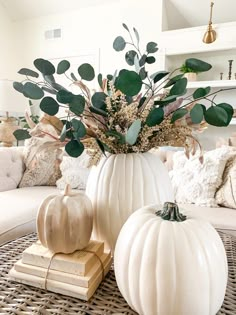 some white pumpkins are sitting on a table