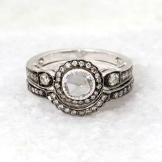 a close up of a ring with diamonds on it's sides and in the middle