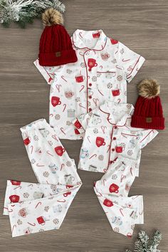 *Adult & child sets sold separately* Pajama set comes with a short sleeve top and matching pants White cookies & hot cocoa print fabric lends sweet, seasonal charm Soft fabric provides cozy, all-night comfort Perfect for bedtime or relaxing movie nights in Cozy up with some hot cocoa this season in our matching Cookies & Hot Cocoa Pajamas! These pajama sets come with a short sleeve button-up top and pair of matching pants. Both pieces are made from a soft fabric blend for comfortable wear, with