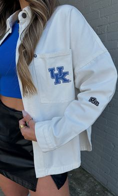 The pop of blue your game day look needed to cheer on our CATS! Wear this jacket oversized with a leather skort for a classic, but edgy look! This oversized jacket features a classic snap button front, collar, pocket and rounded hem to make a perfect breezy denim overshirt! Model is 5'6" with a 32DD bust, 27" waist, 36" hips, and wearing a large for a more oversized fit. Model usually wears size 2/4. Designed to fit oversized for an effortless and relaxed look. Stay true to size or size up for e Sporty Fall Outerwear For Game Day, Sporty Outerwear For Game Day In Fall, Urban Outerwear For Game Day In Fall, Urban Style Outerwear For Game Day In Fall, Collegiate Style Outerwear With Pockets For College, Spring Campus Outerwear With Long Sleeves, Collegiate Outerwear With Pockets, School Spirit Long Sleeve Outerwear For Game Day, Oversized Spring Outerwear In College Style