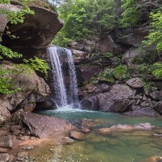 there is a waterfall in the middle of some rocks