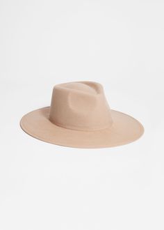 This classic hat has a seamless construction that gives it a smooth, streamlined appearance. Made from structured wool-felt, it has a shallow divot at the top and a slim tonal grosgrain band around the crown. Classic Spring Fur Felt Fedora, Classic Felt Hat With Curved Brim For Fall, Classic Curved Brim Felt Hat For Fall, Classic Fur Felt Hat For Spring, Classic Solid Felt Hat With Flat Crown, Solid Flat Crown Hat For Fall, Fall Flat Crown Felt Hat, Classic Solid Hats For Fall, Classic Fall Hats