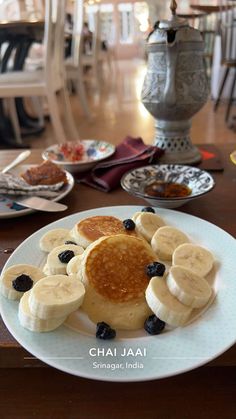 pancakes with bananas and blueberries on a plate