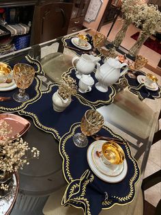 the table is set with gold and white dishes