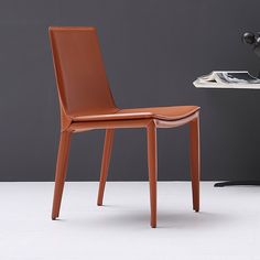 a brown chair sitting next to a white table