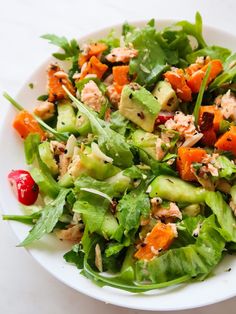 a white bowl filled with salad on top of a table