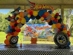 a birthday party with cars and balloons