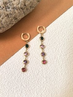 🌟 Indulge in luxury with our Colorful Zircon Drop Earrings. Crafted from 18K gold plate, these handmade earrings feature vibrant zircon stones in a huggie hoop drop design, making them a true fashion statement. Elevate any outfit and gift them to a special woman in your life. * 2 3/8" (61mm) drop * 1/2" (13mm) width * Hinge with snap-post closure * Stainless steel, zircon * 14k-gold plate 🌟 Helpful info: Protect your precious jewelry by keeping it away from water and harsh chemicals, such as l Drop Design, Drops Design, Etsy Earrings Dangle, Precious Jewelry, Handmade Earrings, Fashion Statement, Favorite Jewelry, Jewelry Earrings Dangle, Dangle Drop Earrings