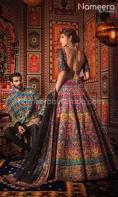 Pakistani Bridal Lehenga Choli in Black Color is beautifully embellished with multi-colored embroidery, detailed artwork with threads, sequins, beads, glitter and mirror work. Perfect combination of rainbow colored embroidery on the graceful black color makes it a beautiful and trendy Bridal Lehenga Choli. Choli: Magnificent black choli is embellished with pearls, crystals, sequins, dabka, mirror work and colorful gleaming handwork details. Its graceful neckline and stylish border makes it a per Pakistani Bridal Lehenga, Nomi Ansari, Sangeet Outfit, Indian Outfits Lehenga, Indian Bridal Outfits, Bridal Lehenga Choli, Dress Indian Style, Indian Wedding Outfits, Lehenga Designs