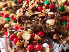 a close up of some candy bars with nuts and chocolate toppings on top,