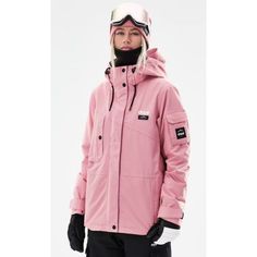 a woman wearing a pink jacket and ski goggles standing in front of a white background