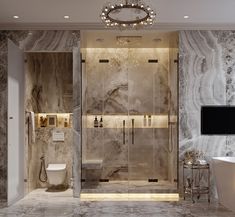 a bathroom with marble walls and flooring is shown in this image, it has a tv on the wall