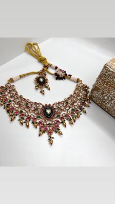 This Gorgeous Sabyasachi inspired Victorian Necklace with matching earrings. Comprises of Fine Oversized Uncut Kundan polki stones and Ruby color hangings This choker is flexible and takes the shape of the neck. Fine quality and craftsmanship. Perfect for desi weddings. Necklace comes in drawstring cord therefore adjustable Earrings length: Approx 3 inches Festive Kundan Set With Intricate Design, Kundan Chandbali Choker With Intricate Design, Heavy Kundan Choker Necklace For Festive Season, Festive Kundan Bridal Choker Necklace, Heavy Kundan Choker For Festive Occasions, Diwali Kundan Choker With Tilla, Kundan Sets With Intricate Design For Diwali, Traditional Kundan Sets With Intricate Design, Intricate Chandbali Sets For Festivals