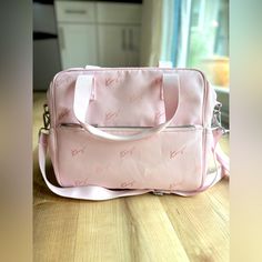 a pink bag sitting on top of a wooden table