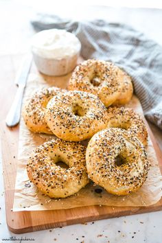 bagels with poppy seed sprinkles on a cutting board