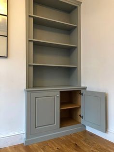 an empty bookcase in the corner of a room