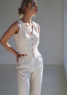 Chic Fitted Vest For Day Out, Chic Linen Vest For Day Out, Chic Fitted Tank Vest, Elegant Sleeveless Blouse Vest For Day Out, Elegant Sleeveless Vest For Day Out, Classic Spring Vest, Sleeveless Linen Vest For Day Out, Classic Fitted Tank Vest, Classic Beige Vest Top