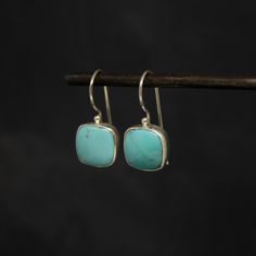 A stunning pair of natural turquoise and sterling silver drop earrings with a hook fitting. Dimensions: * Length: approx 2.5cm  * Width: approx 1.2cm  Materials: * Sterling Silver * Turquoise* *please note that these are natural turquoise gemstones that will differ from those photographed, making each pair unique.  Beyond Biasa creates unique jewellery that is inspired by antique and tribal designs from around the globe. All of our pieces are handmade so please allow for slight variations in siz Gemstone Drop Earrings, Birthstone Earrings, Sterling Silver Drop Earrings, Earrings Turquoise, Birthstone Earring, Square Earrings, December Birthstone, Everyday Earrings, Silver Drop Earrings