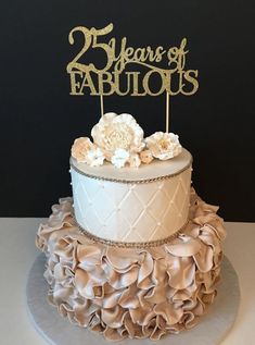 a two tiered cake decorated with flowers and the words 25 years of fabulous on top