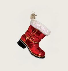 a red boot ornament hanging on a white wall