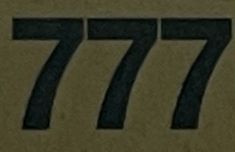 the number 777 is written in black on brown paper