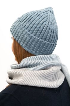 a woman wearing a blue hat and scarf