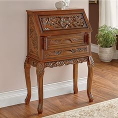 an ornately carved wooden desk in the corner of a room with hardwood flooring