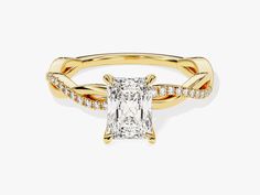 a yellow gold ring with a princess cut diamond