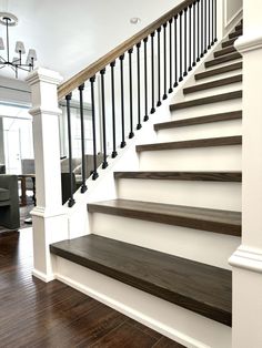 a staircase with wooden steps and black railing