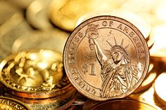 a pile of gold coins with the statue of liberty on one side and another in the middle