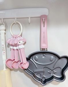 the kitchen utensils are hanging on the wall next to the cookie cutters