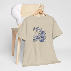 This tee is a classic fit, ensuring a comfy and relaxed wear for any casual or semi-formal occasion. It is made from 100% US cotton, ethically grown and harvested, making it sustainable and highly durable. Ideal for beachgoers and summer enthusiasts. Relaxed Fit Cotton T-shirt For Vacation, Beachy Cotton T-shirt With Text Print, Vacation Cotton T-shirt With Text Print, Beach Season Graphic Tee With Text Print, Graphic Tee With Text Print For Beach Season, Beachy Cotton T-shirt With Relaxed Fit, Vacation Graphic Tee With Crew Neck, Vacation Graphic Tee With Text Print, Beachy Cotton T-shirt For Vacation