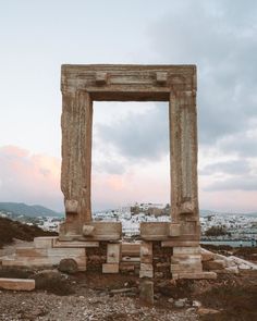 an old stone structure sitting on top of a dirt field