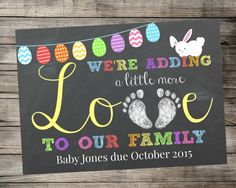 a chalkboard sign that says we're adding a little more love to our family