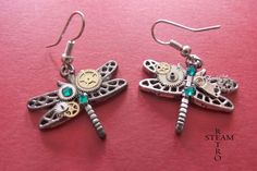 The perfect gift for that someone special! These enchanted dragonflies come straight to you from a Steampunk fairytale near you! Made from Tibetan Silver ,featuring a conundrum of cogs and gears as befits any steampunk artifact, and finished with Swarovski emerald gemstones! Perfect for any occasion! When you buy from Steamretro you will receive a fantastic Handmade piece of jewelry, quite distinct from any other boutique! We offer FREE shipping on the second any any subsequent items when you sh Steampunk Jewelry Earrings, Silver Steampunk Dangle Jewelry, Handmade Silver Steampunk Earrings, Steampunk Silver Metal Earrings, Cogs And Gears, Steampunk Nickel-free Earrings As Gift, Steampunk Earrings, Jewelry Christmas, Steampunk Jewelry