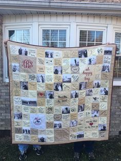 a person standing in front of a house holding up a large quilt with pictures on it