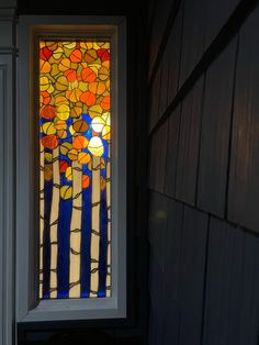 a stained glass window in the corner of a house