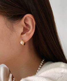 These dainty hoops feature a luminous pearl, perfect for adding a touch of elegance to any outfit. Available in both 18K gold and silver, these hoops are a must-have for any fashion-forward individual. Hoop size: 7.5 x 12mm Dainty Hoop Earrings With Pearl Chain, Pearl Hoop Huggie Earrings, Trendy Gold Hoop Earrings With Pearls, Classic Gold Hoop Earrings With Pearl Chain, Minimalist Hoop Pearl Earrings For Formal Occasions, Formal Minimalist Hoop Pearl Earrings, Gold Minimalist Hoop Earrings With Pearl Chain, Formal Hoop Earrings With Pearl Charm, Classic Pearl Earrings Tarnish Resistant